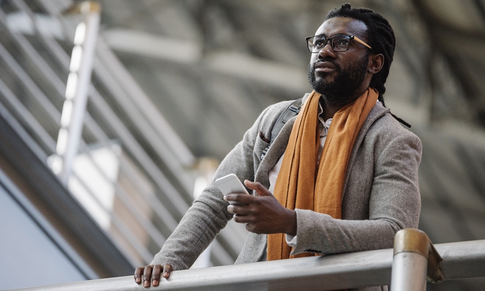 African American businessman outdoors using cell phone