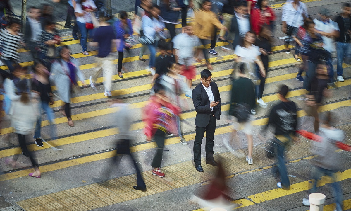 man recieving notification in busy street