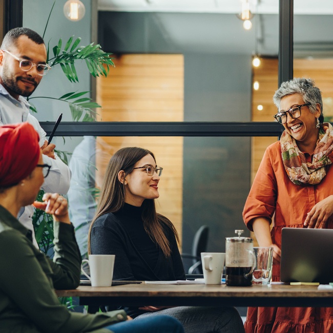 Cheerful Businesspeople Having A Meeting In A Boardroom